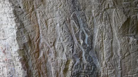 ancient petroglyphs etched into stone walls from the stone age. qubustan, azerbaijan