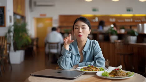 young woman dining and working in a cafe