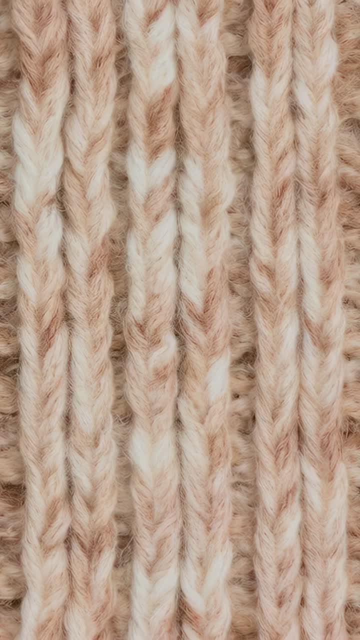 Vertical video: Shifting camera revealing knitted swatch changing focus at close-up, with yarn halo