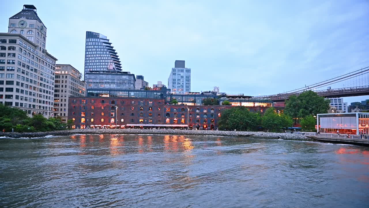 Watching modern New York, USA travelling on the board of the riverboat. River tour by metropolis at sunset time