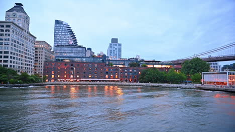 watching modern new york, usa travelling on the board of the riverboat. river tour by metropolis at sunset time