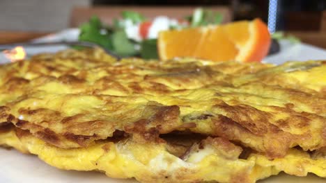 pouring hot sauce on a delicious breakfast omelet, close up