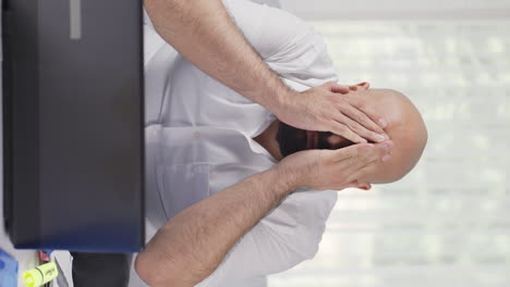 Vertical-video-of-Home-office-worker-man-making-cute-gesture-at-camera.