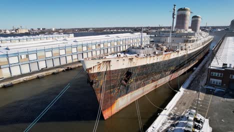 ss united states drone snow right to left of bow of abandoned historic ship docked in philadelphia