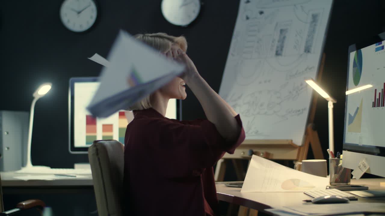 Happy business woman throwing document in night office.