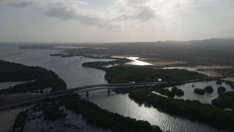 drone pulls out revealing these bridges, mangrove forests on both sides, and the horizon with an awesome landscape as the sun is setting, porlamar, margarita island, venezuela