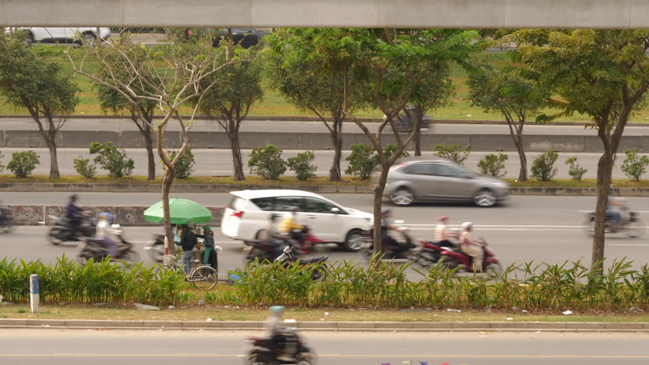 Timelapse of overcrowded Vietnamese highway with scooters and cars.