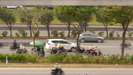 timelapse of overcrowded vietnamese highway with scooters and cars.