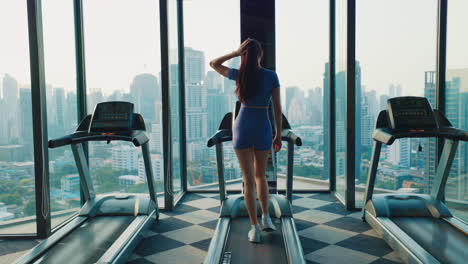woman working out on treadmill with city view