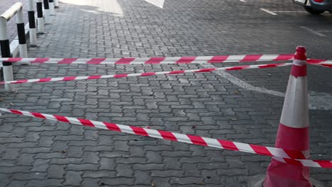 4k: police red and white tape, do not cross blocking city street, demonstration, protest or crime scene-1