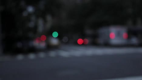 Blurred-shot-of-traffic-and-taxi-cars-passing-by-in-New-York-city-during-low-light-part-of-the-day