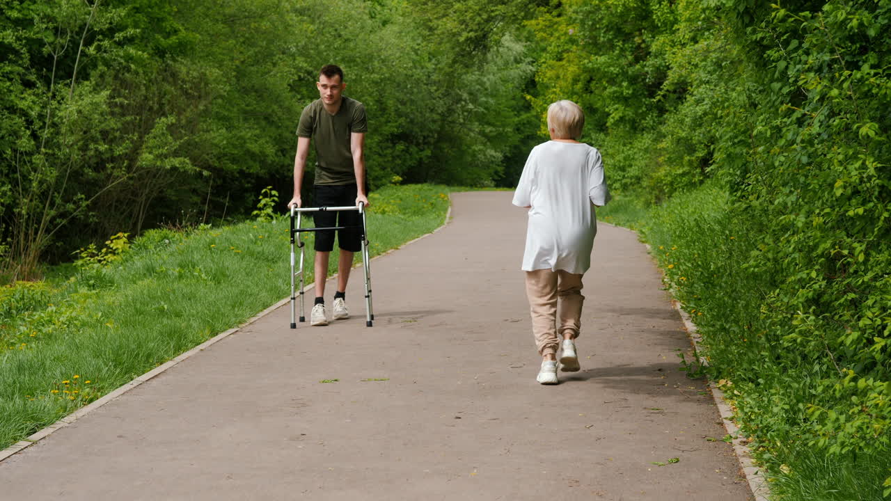 Young Man Assisting Elderly Woman on Walking Path
