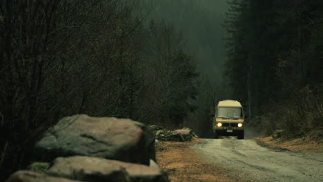 misty forest road with van