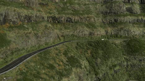 vehicle driving on high mountain road in madeira, steep slope, aerial