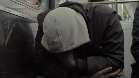 homeless man dozing when traveling by metro train