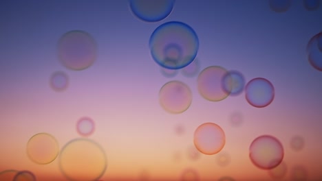 soap bubbles on sky at sunset summer slow motion. bright background multicolored bubbles smoothly fly in sky. childhood, freedom. dreams. relax. happiness