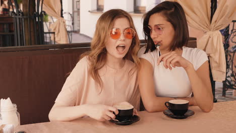 two friends enjoying coffee outdoors