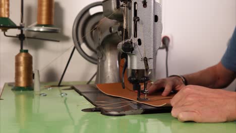 vintage sewing machine in action on leather