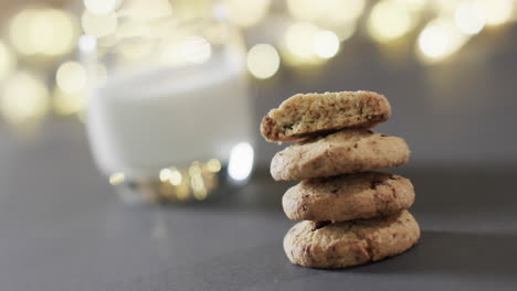 video of christma cookies, glass of miljk and copy space on grey background