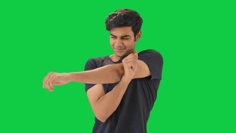 Happy-Indian-boy-doing-full-body-stretch-Green-screen