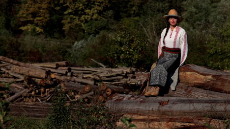 romanian girl sits on the cut trees 2