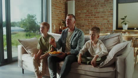 family watching tv and snacking