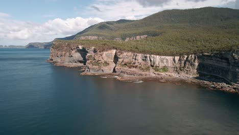 Moving-drone-shot-of-Tasman-National-Park-with-skyscape-at-background-during-daytime-in-Australia