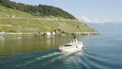 aerial shot passing behind cgn steam belle-epoque ship on lake léman in front of lavaux