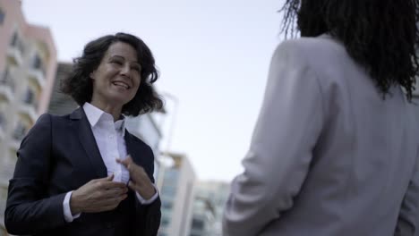 multiethnic businesswomen shaking hands