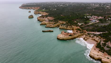 Flying-over-the-Algarve-Coast-on-a-cloudy-day,-slowly-showing-off-the-whole-coastline