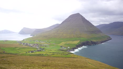 Stunning-handheld-shot-of-Malinsfjall-overlooking-of-Vidareidi,-embraced-by-the-North-Atlantic-Ocean