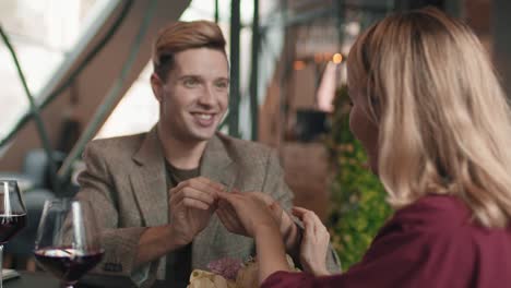 man wearing ring on girl hand