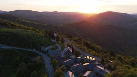 aerial pullback from sunset natural scenery revealing small town of cebreiro, lugo. spain