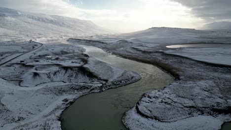 Wunderschöne-Landschaft-Des-Verschneiten-Flusses-Im-Tal-Von-Island,-Luftlandschaft