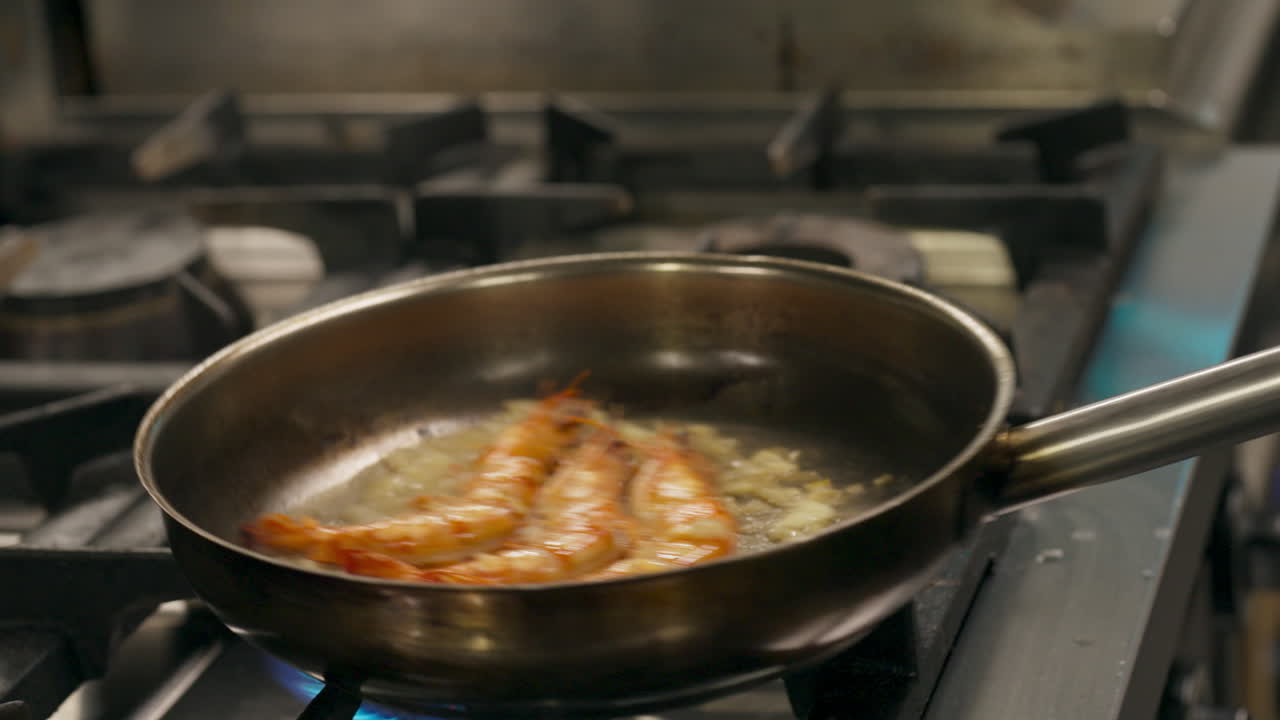 Chef Putting Butter On Shrimps On Frying Pan. - closeup shot