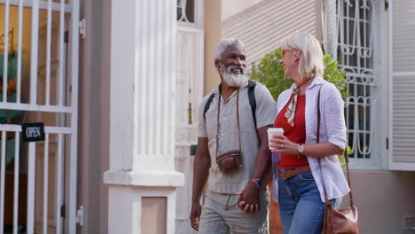 elderly interracial couple walking in the city