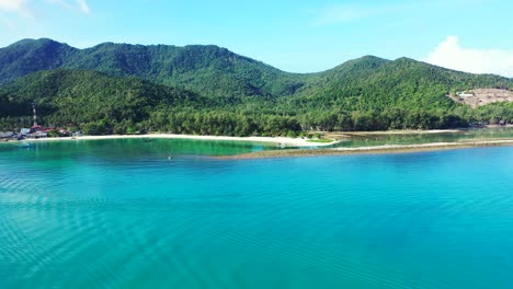 Calm-turquoise-bay-on-beautiful-coast-of-tropical-island-with-white-sandy-beaches-and-lush-vegetation-in-Thailand