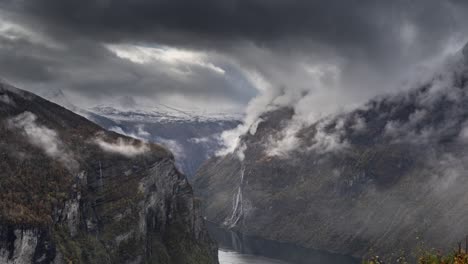 heavy dark clouds whirling above the geiranger fjord