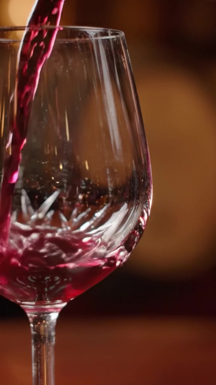 Transizione elegante di un bicchiere di vino: da cristallo vuoto a ricco vino rosso in un affascinante viaggio video di gusto e raffinatezza
