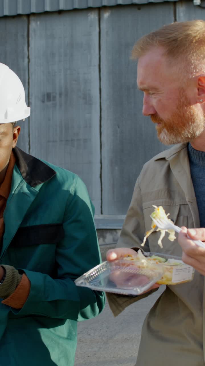 Workers enjoying lunch break at industrial site