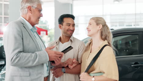 a couple talking to a car salesman