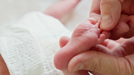Touching a Newborn Baby's Foot