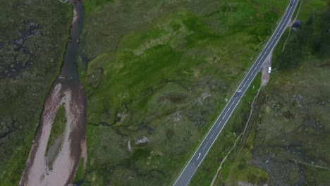 car drive along a winding road in the scottish highlands