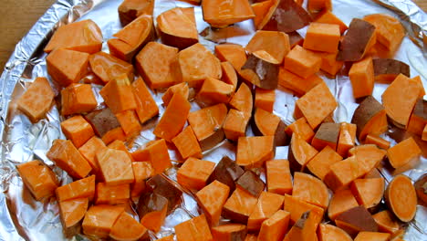 Cubed-sweet-potatoes-getting-seasoned-before-being-put-in-the-oven