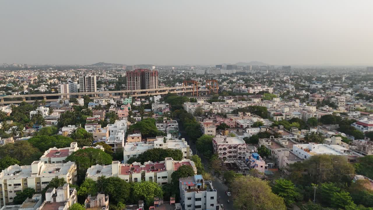 Chennai skyline with metro project cutting through city blocks at sunrise