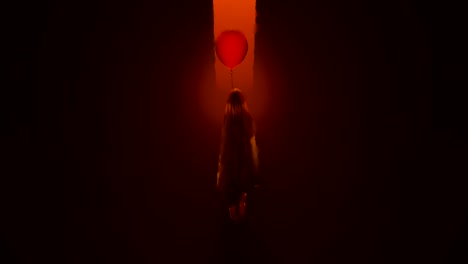 evil spirit of a child with a red balloon floating in a fiery inferno