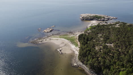 Aerial-view-of-Saltö-island's-serene-coastline-with-lush-greenery-and-clear-blue-waters