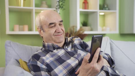 Relaxed-and-peaceful-old-man-using-phone.