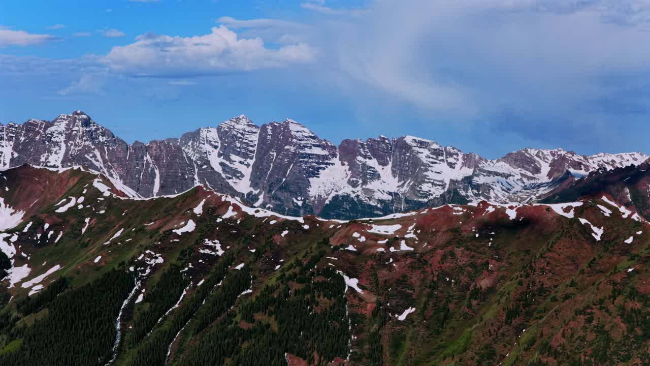 Summit of Maroon peak North Maroon Bells Pyramid Peak aerial drone Colorado panorama Aspen Highlands bowl spring summer sunny morning blue sky clouds Rocky Elk Mountains Range pan left
