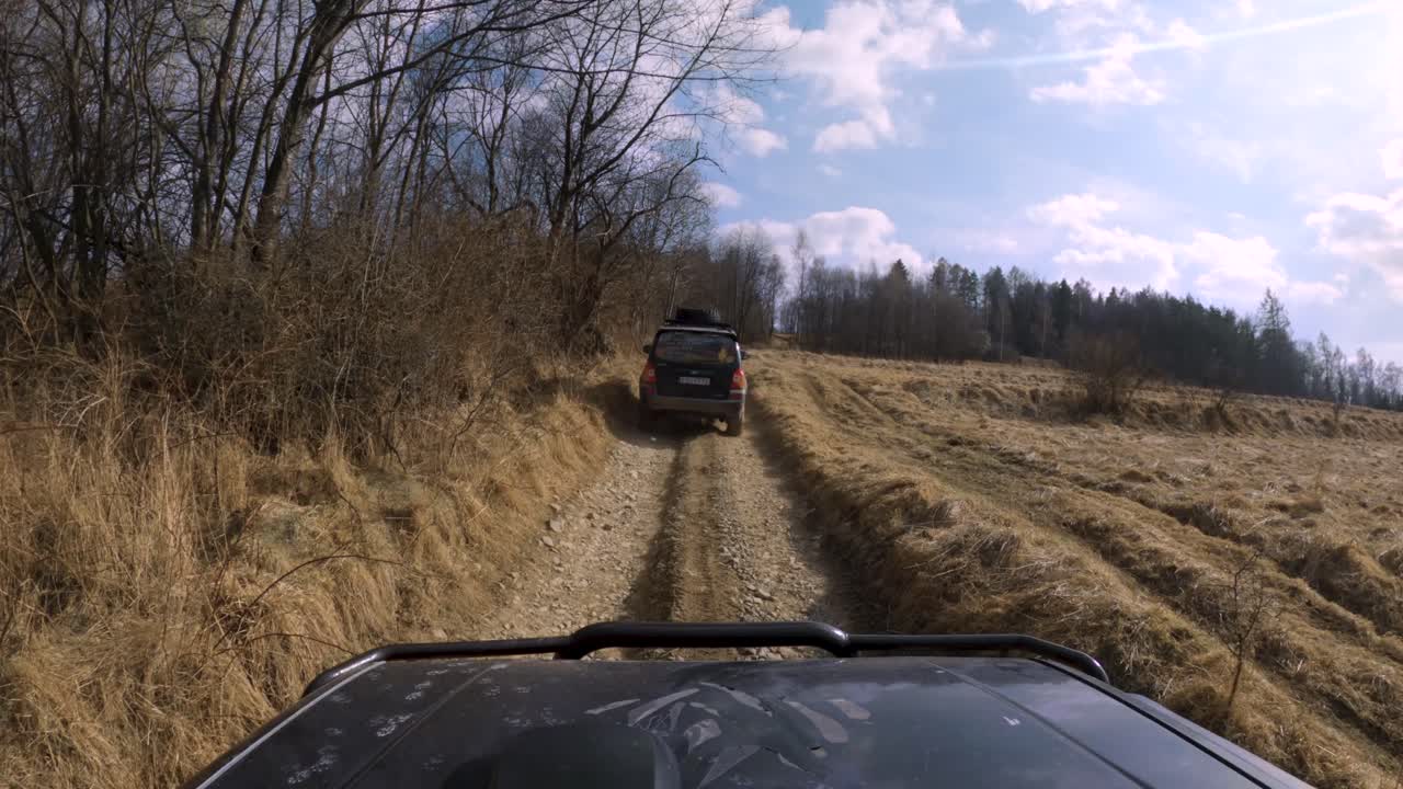 4x4 jeeps driving on gravel and dirty roads, early spring - GoPro window view